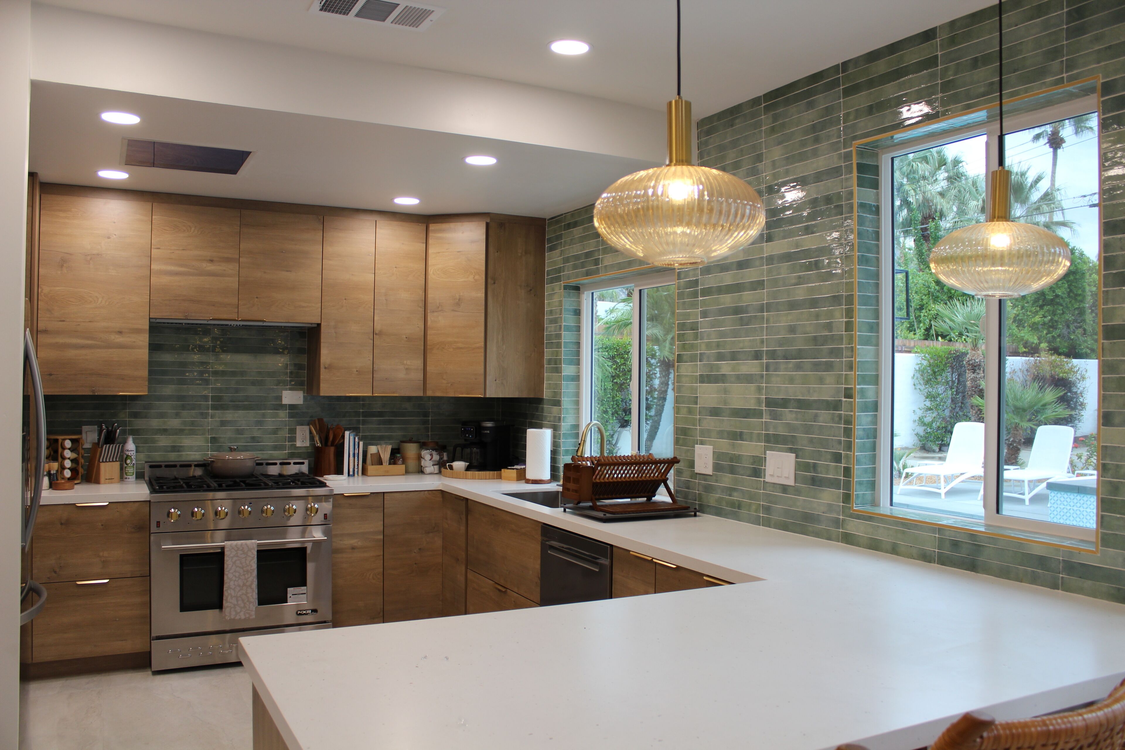 A modern kitchen with wooden cabinets, stainless steel appliances, and a large island.