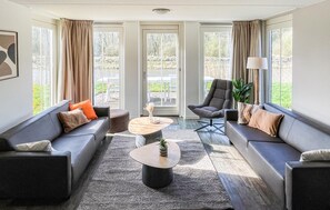 A modern living room with two sofas, a coffee table, and a chair. - Beautiful home in Witmarsum (Witmarsum)