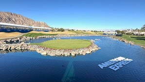 A golf course with a water feature and the text "AMERICAN EXPRESS" on the water. - Hacienda-Resort Style-Golf, Music, & Art Paradise in La Quinta, PGA West Stadium (La Quinta)