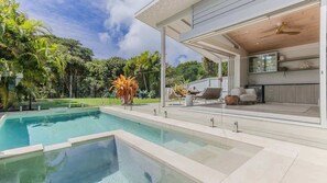 A modern outdoor pool area with a clear view of the sky and surrounding greenery. - Daybreak Shores (Casuarina)