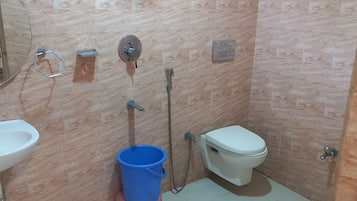 A small bathroom with a toilet, bidet, and sink.