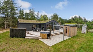 A modern house with a patio, a hot tub, and a deck. - VillaVilla 944 - Blokhus, Nordjylland (Blokhus)