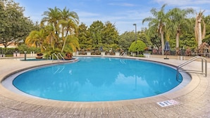 A swimming pool with a 6ft depth limit, surrounded by palm trees and a paved deck. - Thematic 4 bdr House Near Disney - 11-105lv (Kissimmee)