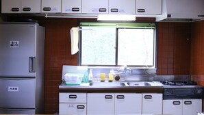 A compact kitchen with a refrigerator, sink, and stove. - Heart Land Hills In Noto 11 Akogare No Log House (Shika)