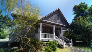A house with a porch, a staircase, and a small garden.