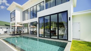 A modern two-story house with a swimming pool, large glass windows, and a well-maintained lawn. - Camellia Pool Villa,Near Nai Harn And Rawai Beach (Tambon Rawai)