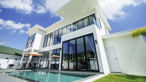 A modern two-story house with a swimming pool, large windows, and a flat roof. - Camellia Pool Villa,Near Nai Harn And Rawai Beach (Tambon Rawai)