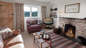 A cozy living room with a fireplace, a television, and a comfortable seating area. - Brightworthy Farm, Withypool on Exmoor (Withypool)