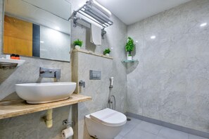 A modern bathroom with a white sink, a toilet, a shower, and a mirror. - Hotel All Time Residency New Delhi (New Delhi)