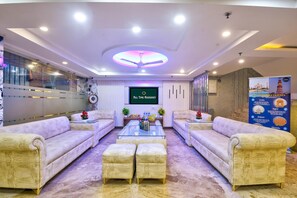 A spacious living area with plush sofas, a coffee table, and a television. - Hotel All Time Residency New Delhi (New Delhi)