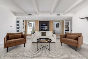 A modern living room with two sofas, a coffee table, and a large window. - Modern Desert Escape/Sleeps up to 8/Pool & Hot Tub (Fountain Hills)