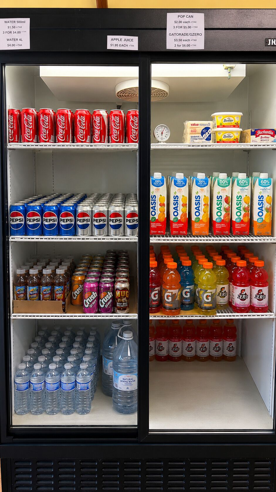 A vending machine stocked with beverages including Coca-Cola, Pepsi, Gatorade, and various juices.