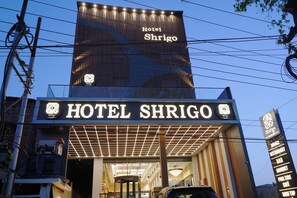 The exterior of Hotel Shrico with a prominent sign, a modern design, and a visible entrance. - Shrigo Hotel Banaras - Varanasi (Varanasi)