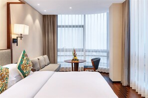 A hotel room with a large bed, a sofa, a small table with a vase, and a chair. - Ssaw Boutique Hotel Swufe Chengdu (Chengdu)