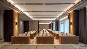 A conference room with rows of tables and chairs, equipped with nameplates and water bottles. - Ssaw Boutique Hotel Swufe Chengdu (Chengdu)