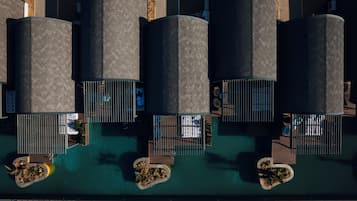 An aerial view of a hotel with multiple cylindrical structures, each with a balcony and a pool area.