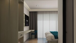 A hotel room with a bed, a desk, and a chair. - Kashiveli Omadhoo (Omadhoo)