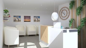 A modern reception area with a wooden reception desk, white chairs, and artwork on the wall.