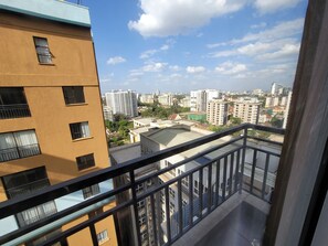 A high-rise building with multiple balconies and a cityscape view. - Phenomenal 3-bedroom/DSQ apartment in vibrant Nairobi neighborhood (Nairobi)