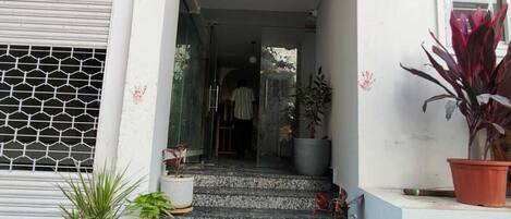 A building entrance with a sign reading "Jyothis Living Spaces".