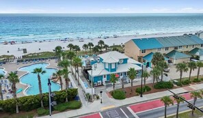 A beachfront hotel with a swimming pool, beach access, and a view of the ocean. - Private Canal View 2bd/2.5bth Townhome - Golf Cart - 5min Walk to Beach (Panama City Beach)