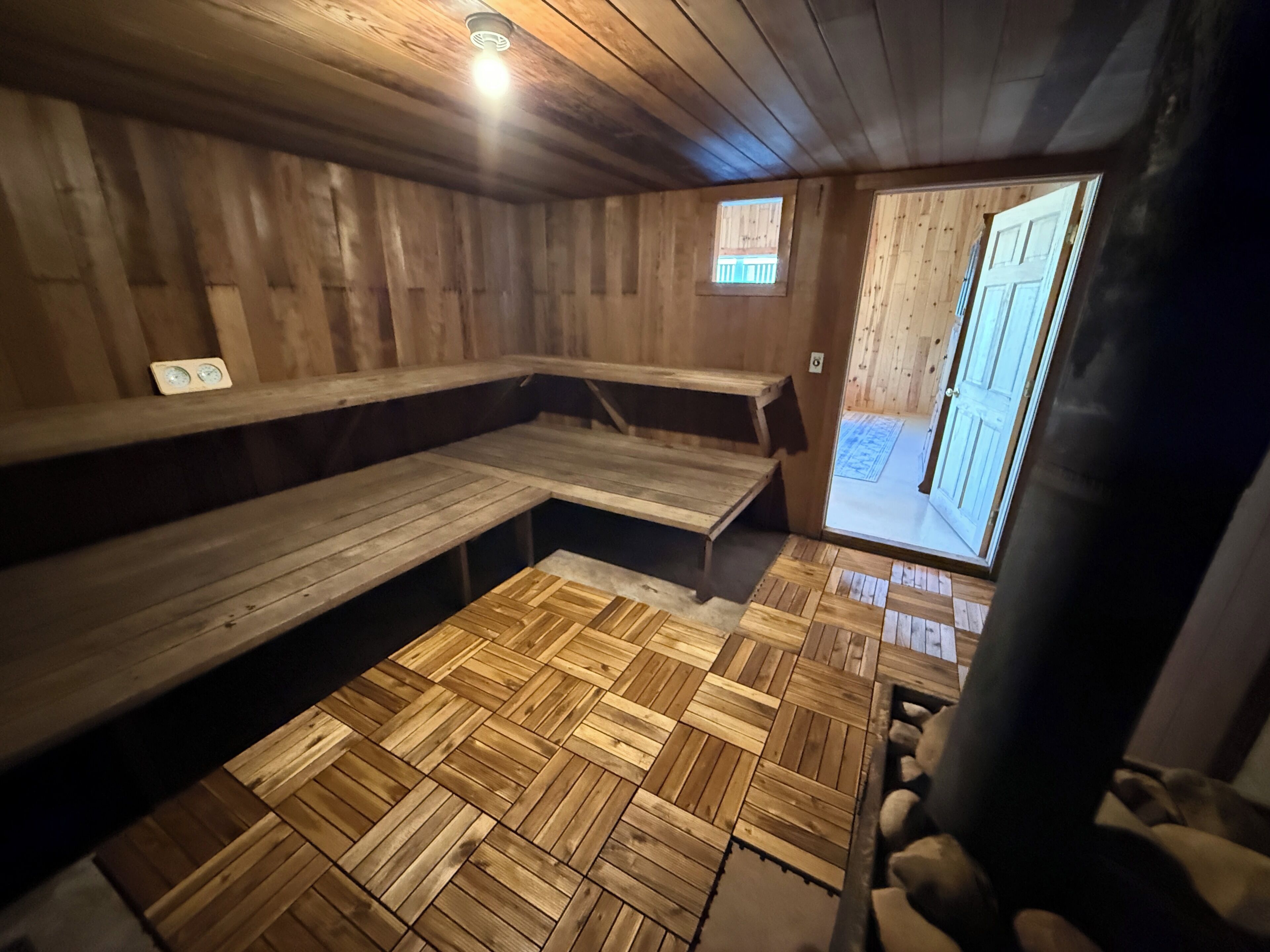A sauna room with wooden benches and a tiled floor.