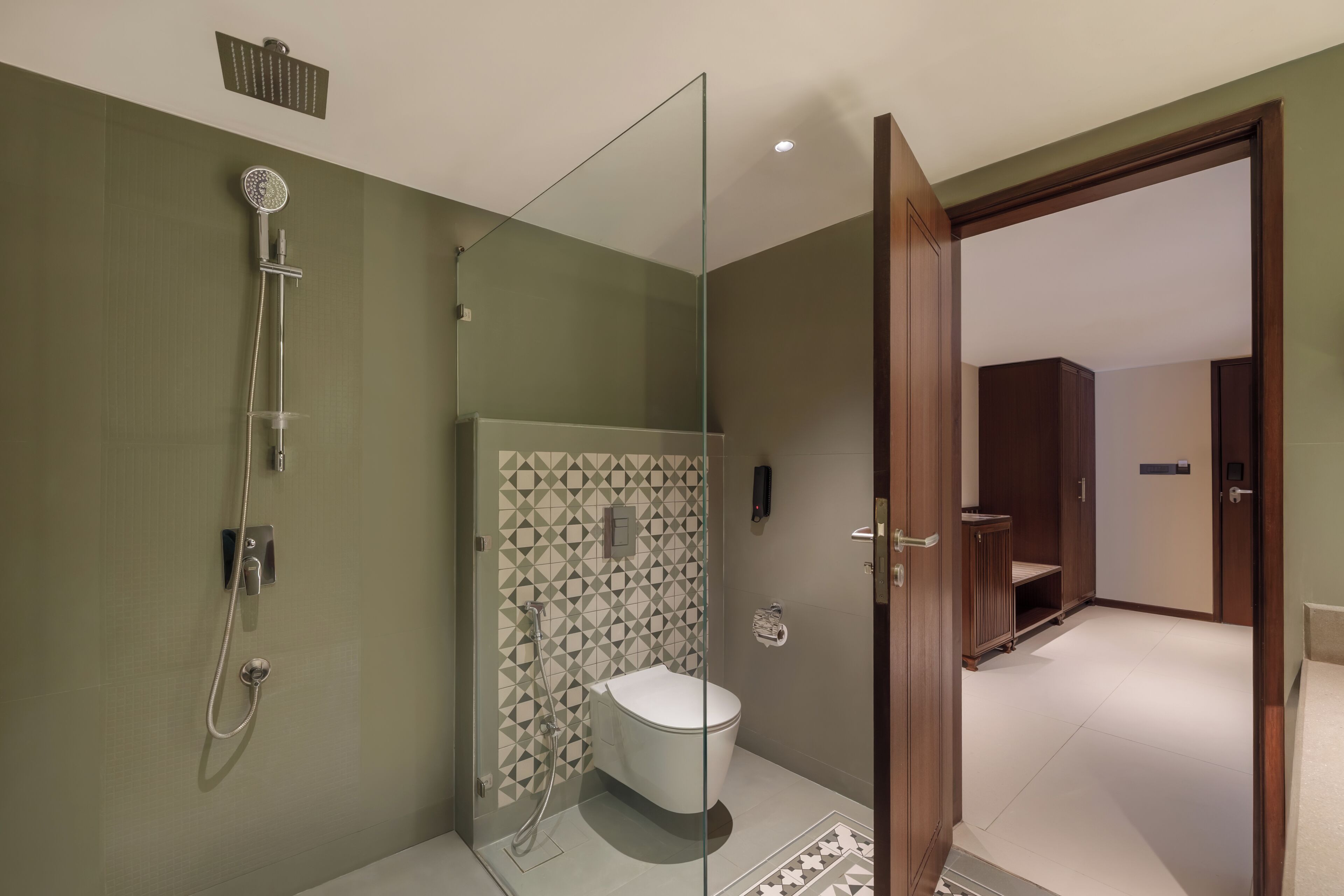 A modern bathroom with a glass-enclosed shower, a toilet, and a vanity.