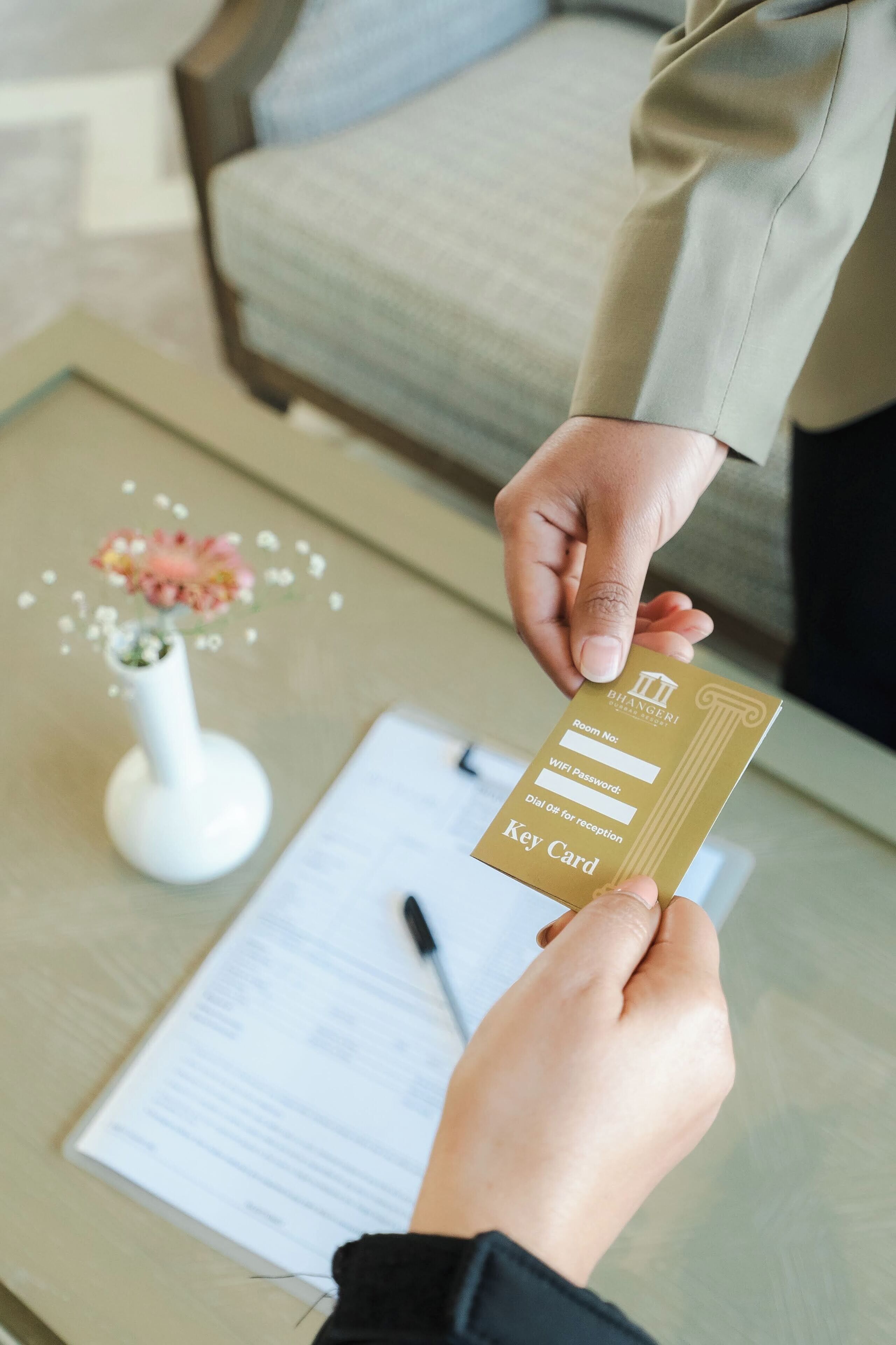 A person holding a key card with text indicating it is for room reception and WiFi access.