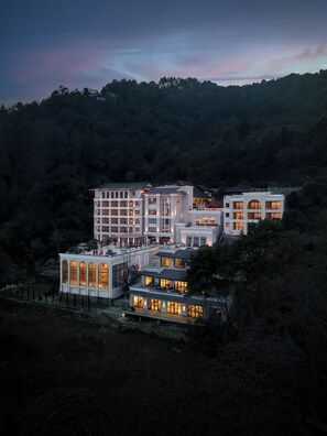 A multi-story hotel with a modern architectural design, featuring multiple balconies and large windows. - Bhangeri Durbar Resort (Baluwapati Deupur)