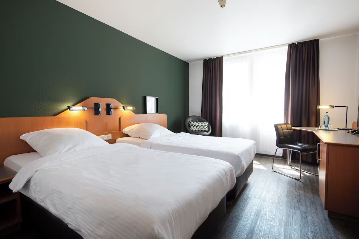 Unwind in bright twin beds with a calm workspace.