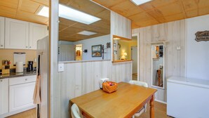 A kitchen with wooden cabinets, a wooden table, and a refrigerator. - 8 Mi to Appalachian Trail! Home w/ Fire Pit (Ceres)