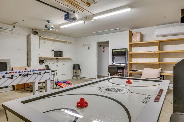 A room with a foosball table, a ping pong table, and a video game console. - Glendale Entertainment Hub! Family Home w/ Pool (Glendale)
