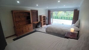 A bedroom with two beds, a wooden wardrobe, a desk, and a chair. - Spacious & Sunny House, Fantastic Bush Views, quiet and central location (East Killara)