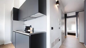 A modern kitchen with a central island, built-in appliances, and a sleek design. - 'Piazzetta' Apartment with Balcony, Wi-Fi and Air Conditioning (Gardola)