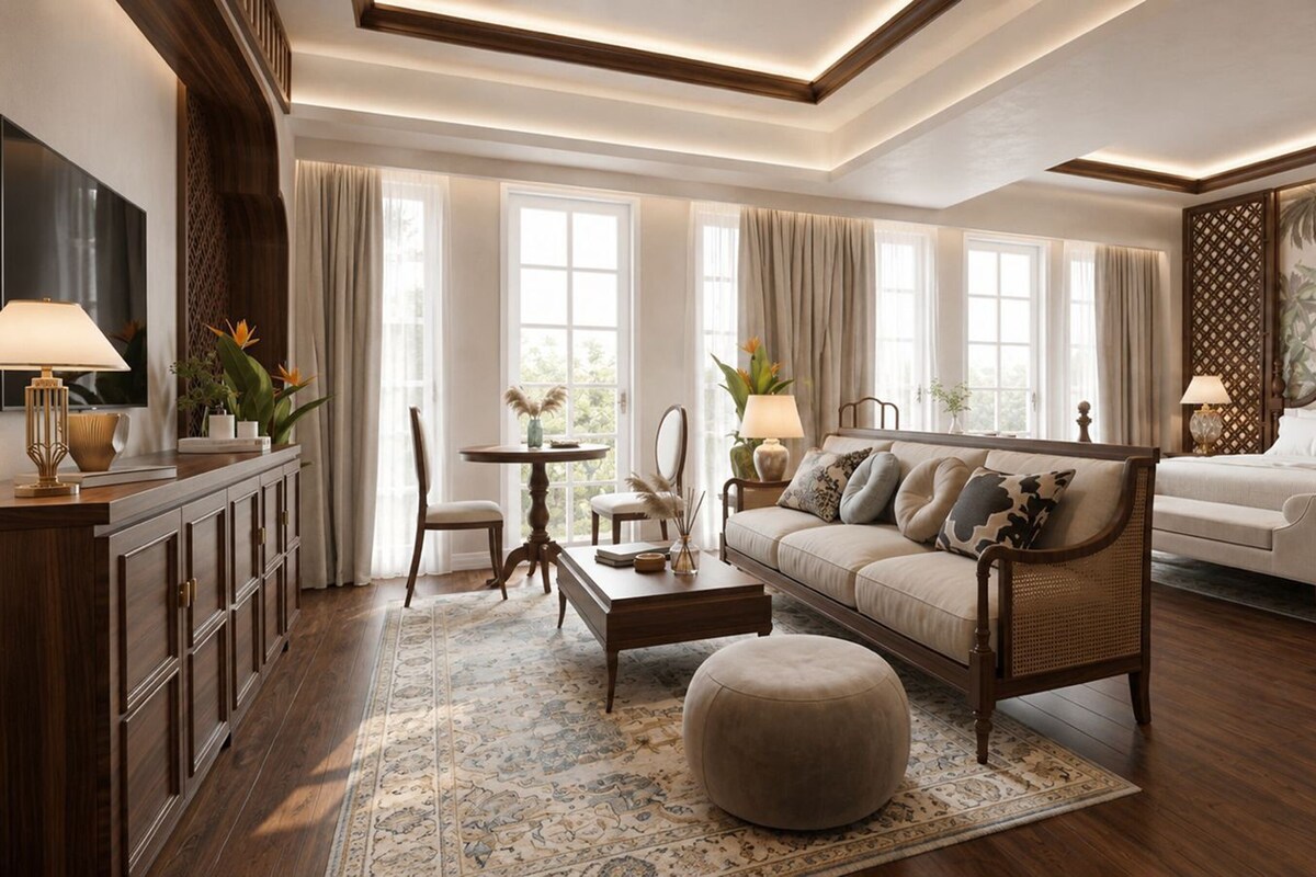 A well-lit living room with a sofa, ottoman, and a dining area with a table and chairs.