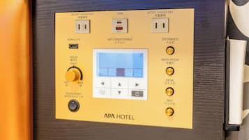 Panel de control con puerto USB, puerto HDMI y pantalla mostrando la configuración de la habitación.