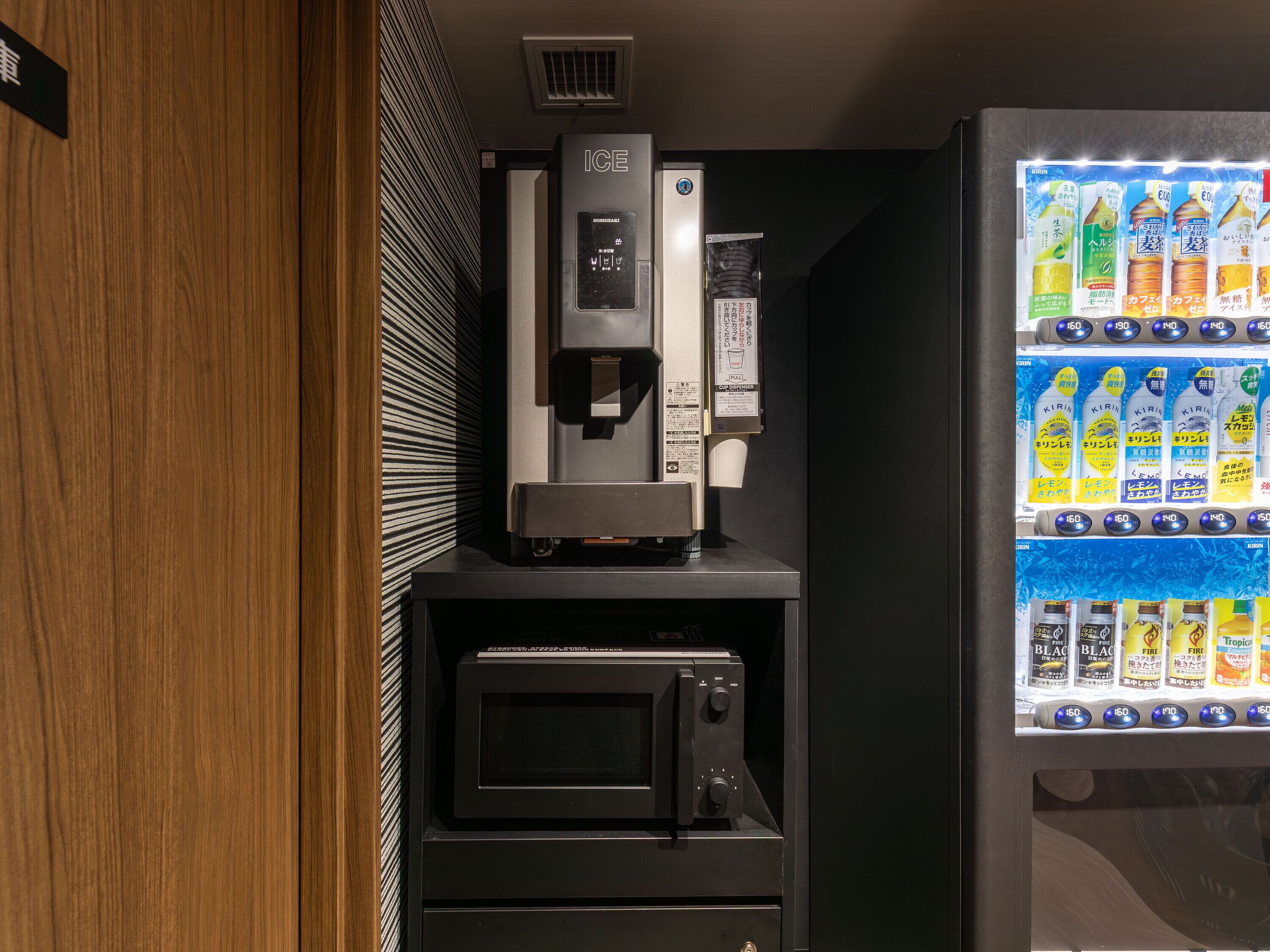 A vending machine with various beverages, a coffee machine, and a microwave.