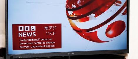 A television displaying BBC News 11CH with a red and white abstract design.