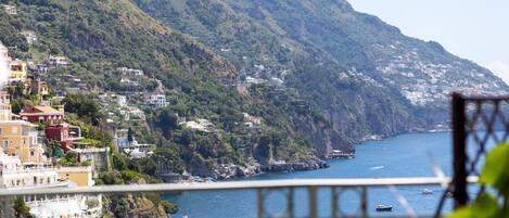A coastal town with buildings on a hillside overlooking the sea.