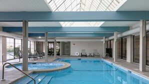 An indoor swimming pool with clear lanes, a hot tub, and lounge chairs. - Bluewater 902 (Orange Beach)