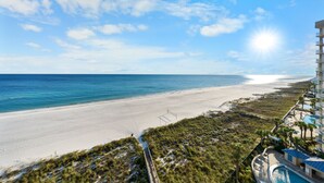 A beachside hotel with a pool, a beach, and a clear sky. - Bluewater 902 (Orange Beach)