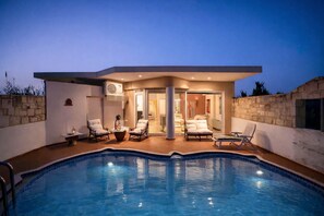 A modern house with a swimming pool, outdoor seating, and a covered patio area. - Villa Joy Mare - Seaside Escape with Private Pool (Agioi Apostoloi)