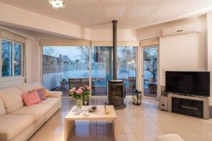 TV, fireplace, offices - Villa Joy Mare - Seaside Escape with Private Pool (Agioi Apostoloi)