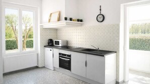 Eine moderne Küche mit weißen Schränken, einer schwarzen Arbeitsplatte, einem eingebauten Ofen, einer Mikrowelle und einem Spülbecken. Links befindet sich ein Fenster und an der Wand eine Uhr.