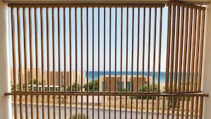 A balcony with a view of the sea and buildings.