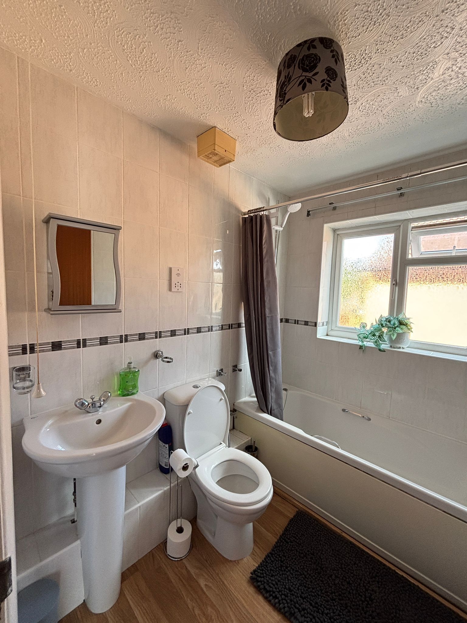A bathroom with a sink, toilet, and bathtub.