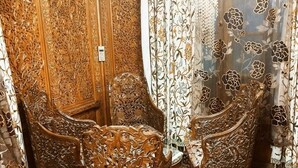 A room with ornate wooden furniture and floral-patterned curtains. - DeLaila Luxury Houseboat by Shahnawaz  (Srinagar)