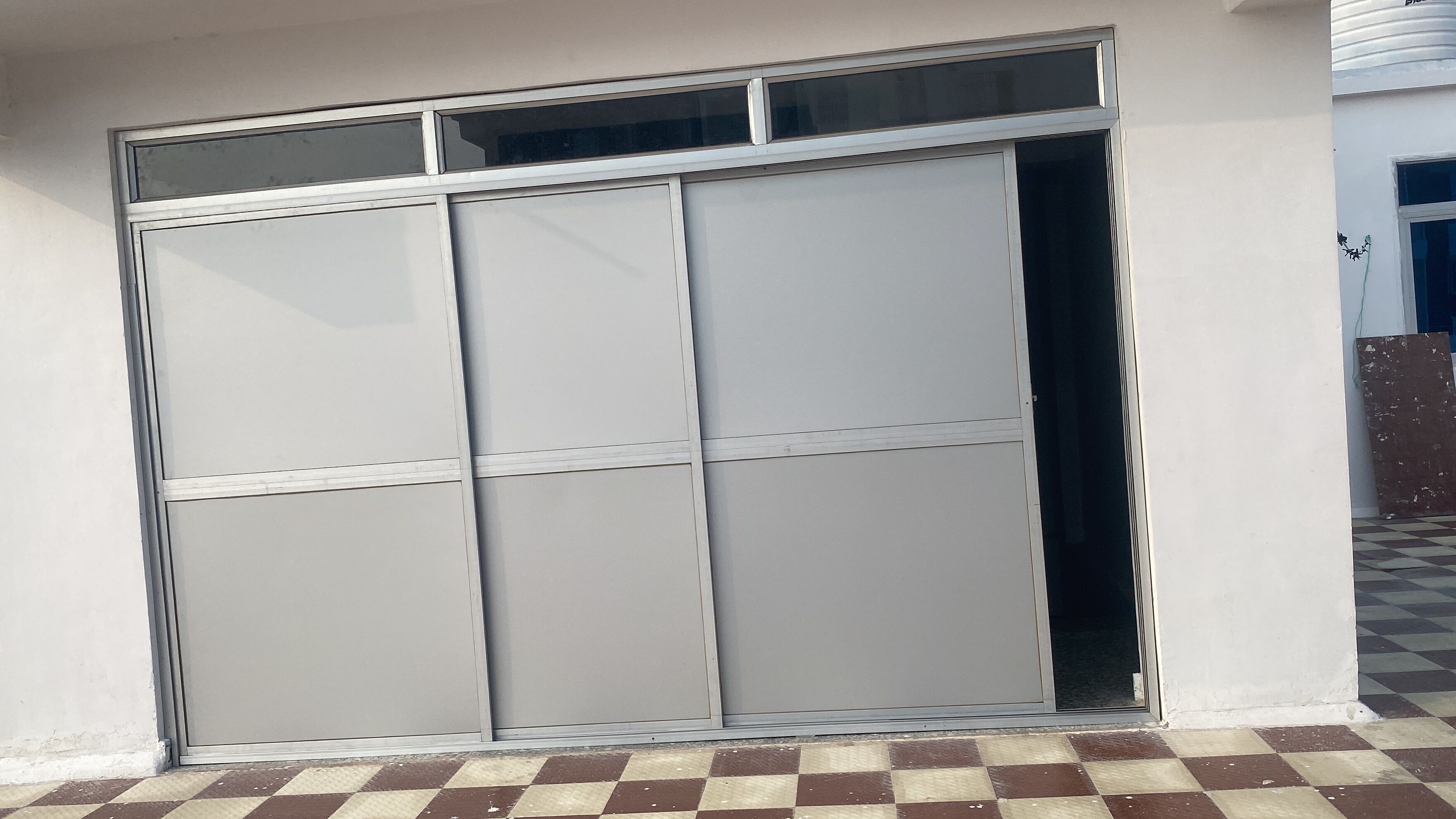 A large sliding glass door with a checkered floor pattern.