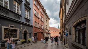 Un carrer estret amb edificis històrics, una botiga a l'esquerra i una botiga de minerals a la dreta.