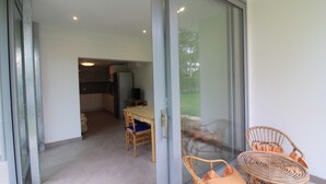 A modern kitchen with a dining area visible through a glass door. - Modern villa 200mt from the beach (Lignano Sabbiadoro)